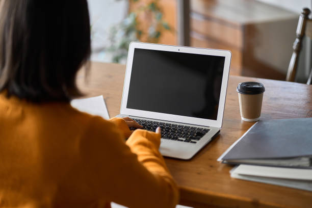 Asian woman looking at website Asian woman looking at website homepage stock pictures, royalty-free photos & images