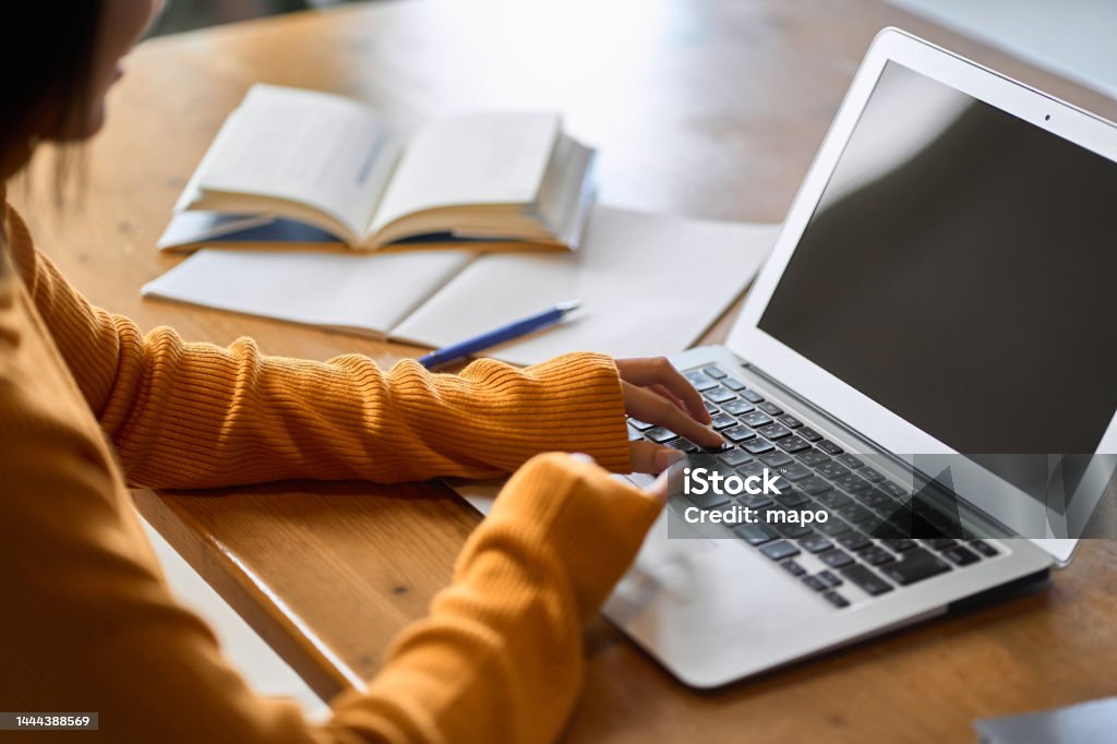 Asian woman's hand studying for qualifications Laptop Stock Photo
