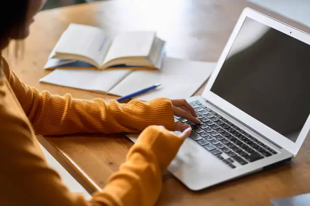 Photo of Asian woman's hand studying for qualifications