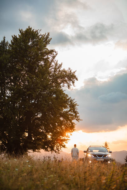 istock Man near car. Sunset in the mountains 1444394885