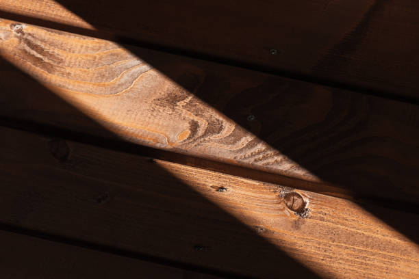 Dark wooden wall with light beam, abstract background photo texture
