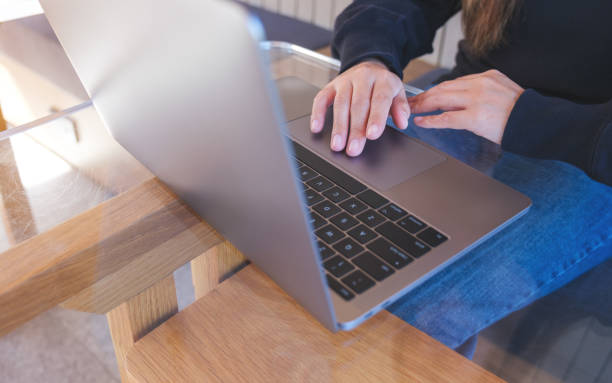 istock Closeup image of a woman working and touching on laptop computer touchpad 1444395916