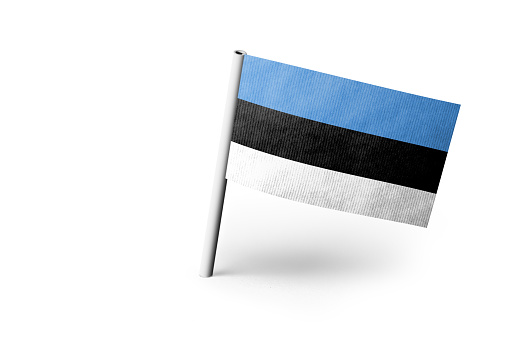 Small paper flag of Estonia pinned. Isolated on white background. Horizontal orientation. Close up photography. Copy space.
