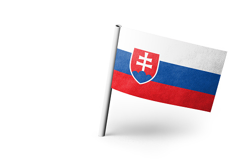 Small paper flag of Slovakia pinned. Isolated on white background. Horizontal orientation. Close up photography. Copy space.