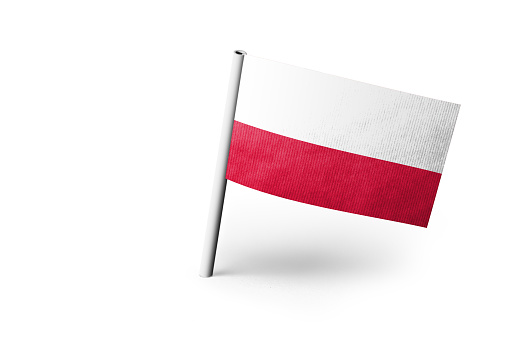 Small paper flag of Poland pinned. Isolated on white background. Horizontal orientation. Close up photography. Copy space.