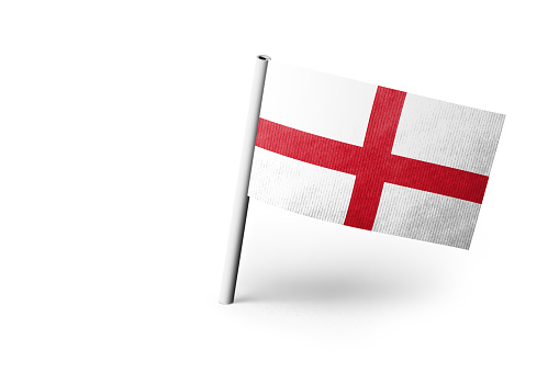 Small paper flag of England pinned. Isolated on white background. Horizontal orientation. Close up photography. Copy space.