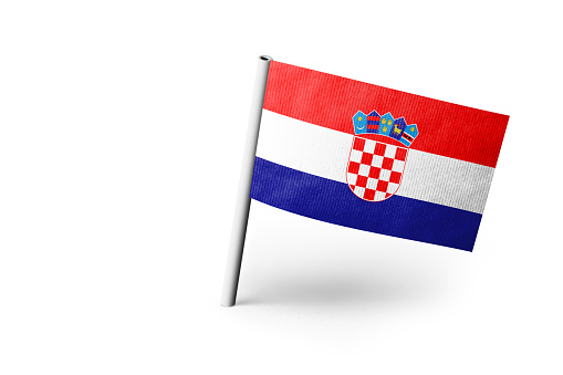 Small paper flag of Croatia pinned. Isolated on white background. Horizontal orientation. Close up photography. Copy space.