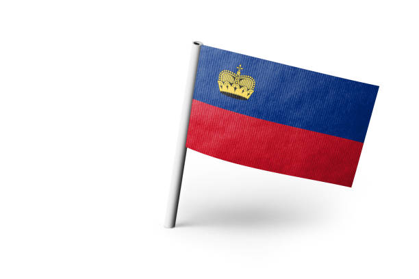 Small paper flag of Liechtenstein pinned. Isolated on white background. Horizontal orientation. Close up photography. Copy space.