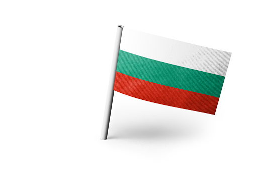 Small paper flag of Bulgaria pinned. Isolated on white background. Horizontal orientation. Close up photography. Copy space.