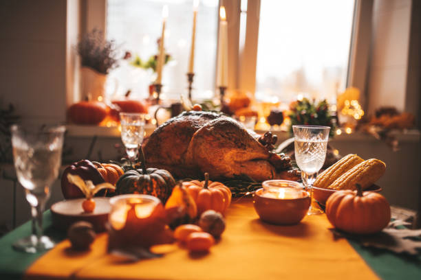 istock Thanksgiving holiday dinner table setting with fall decoration and pumpkins 1444397108