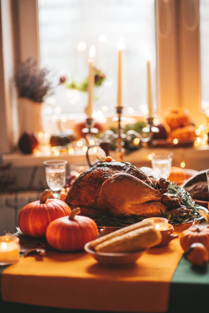 istock Thanksgiving holiday dinner table setting with fall decoration and pumpkins 1444397112