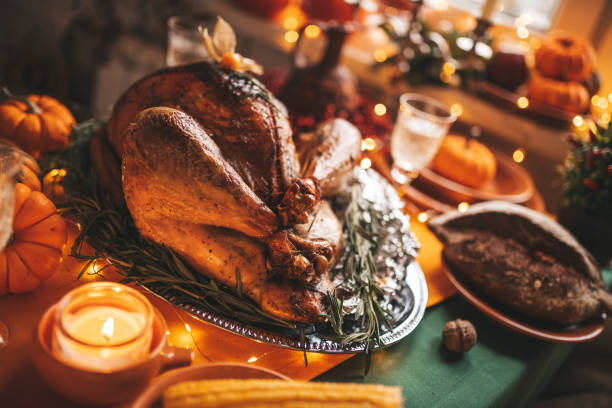 istock Thanksgiving holiday dinner table setting with fall decoration and pumpkins 1444397182