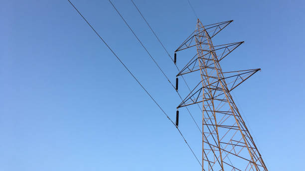 istock Electricity transmission towers with glowing wires 1444398512
