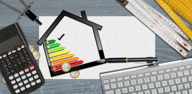 istock House Energy Efficiency Rating - Small Model House on Desk 1444402229