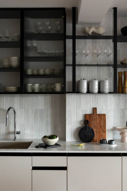 istock Modern composition of kitchen space with gray table, classic top, creative furnitures, tiles on the wall, bowl with avocado and elegant kitchen accessories. Stylish home decor. Template. 1444403101