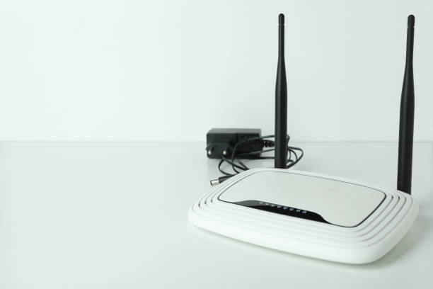 istock Wi-Fi router with external antennas and plug on white background 1444405576