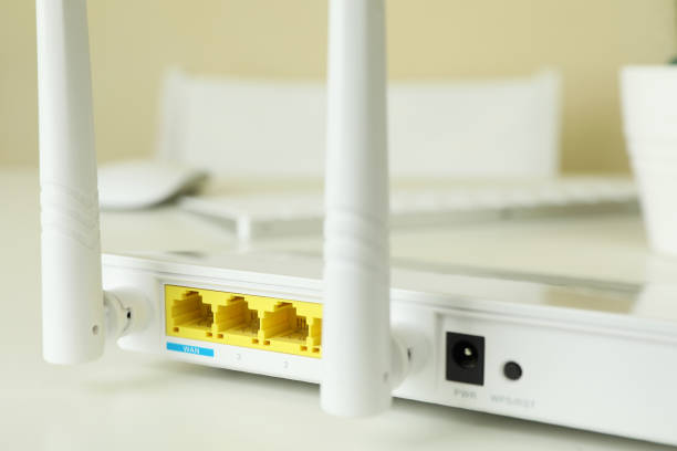 istock Wi - fi router on white table, close up 1444405729
