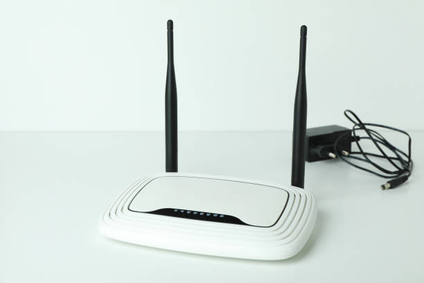 istock Wi-Fi router with external antennas and plug on white background 1444406335