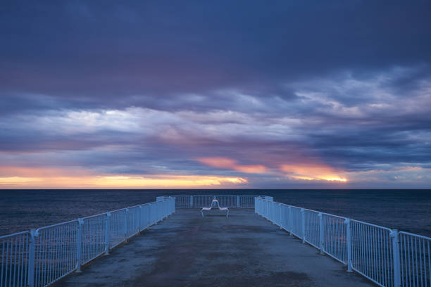 istock deserted pier with dramatic sky over stormy dark sea at sunrise 1444409343