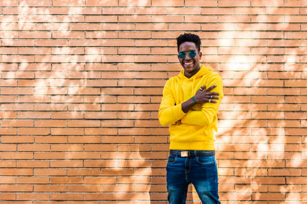 istock Portrait of a smiling african man in a bricks wall 1444410202