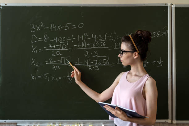 istock Young teacher in classroom against blackboard 1444414059