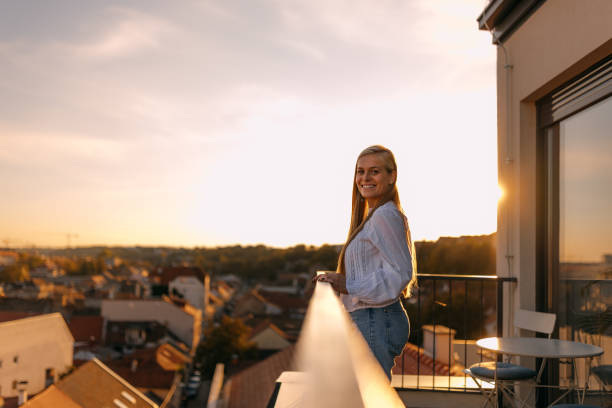 istock Smiling woman posing for the camera, being on the terrace. 1444414679