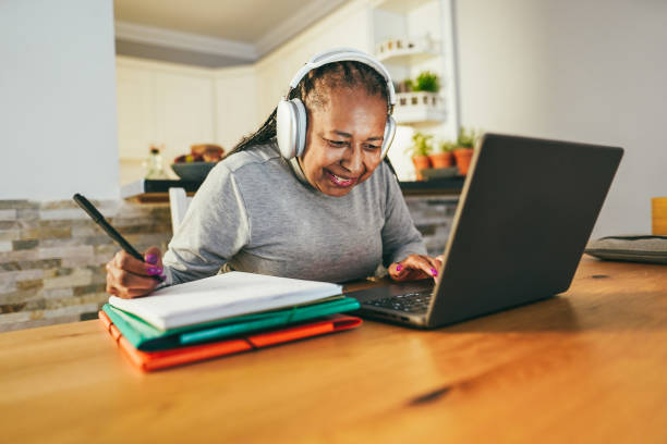 istock Senior woman working from home - Joyful elderly lifestyle, smart work and technology concept - Focus on face 1444414968