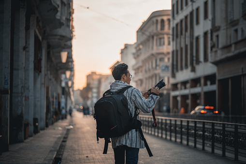Asian Chinese man tourist photographing exploring Casablanca, Morocco in the morning