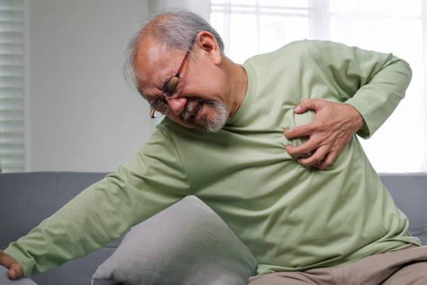 istock heart attack symptoms, Senior heart attack suffering indoor, Elderly hand touching heart, Emergency of senior has heart attack suddenly. face of suffering from unhealthy, healthcare medical 1444417723