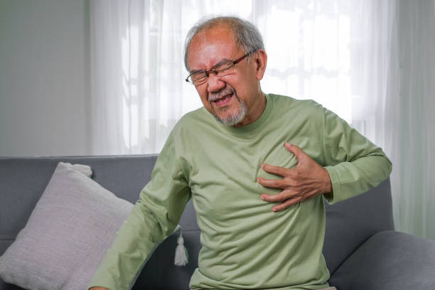 istock heart attack symptoms, Senior heart attack suffering indoor, Elderly hand touching heart, Emergency of senior has heart attack suddenly. face of suffering from unhealthy, healthcare medical 1444417734