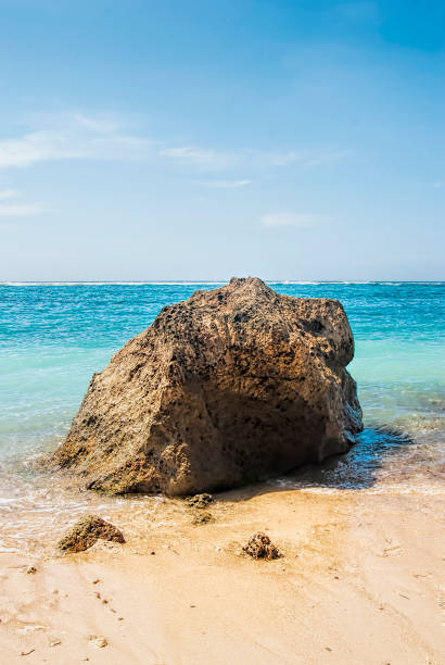 istock Tropical beach with panoramic views and waves, rocks and sand background 1444417967