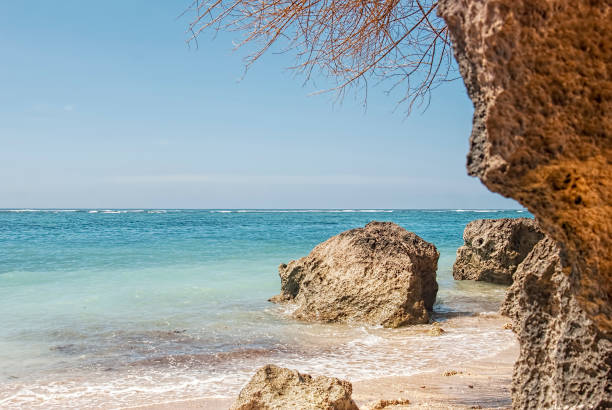 istock Tropical beach with panoramic views and waves, rocks and sand background 1444417994