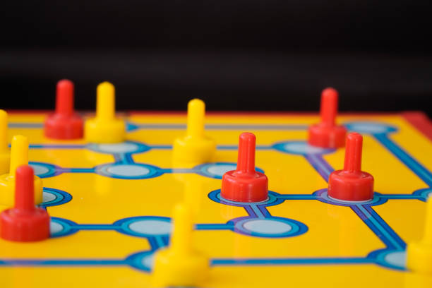 istock board game with red and yellow figures indoor. Intelligence and strategy board game. 1444422676