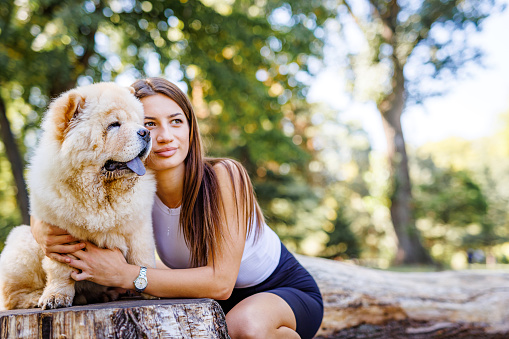 Young woman embrace dog outdoor