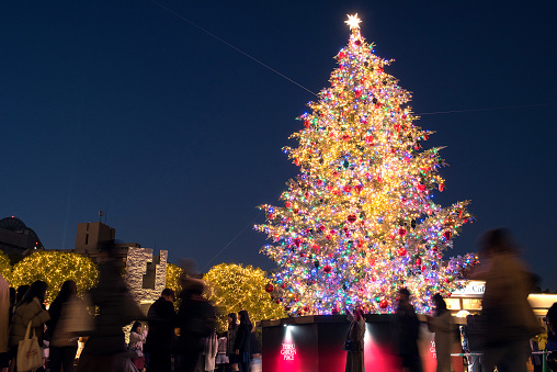Tokyo, Japan - December 23, 2019: Big outdoor Christmas tree and people in Yebisu Garden Place.