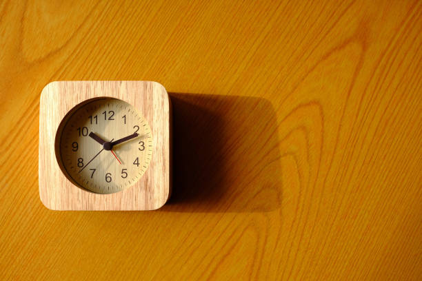 istock Top View of Wooden Clock on the Table Background. 1444429257
