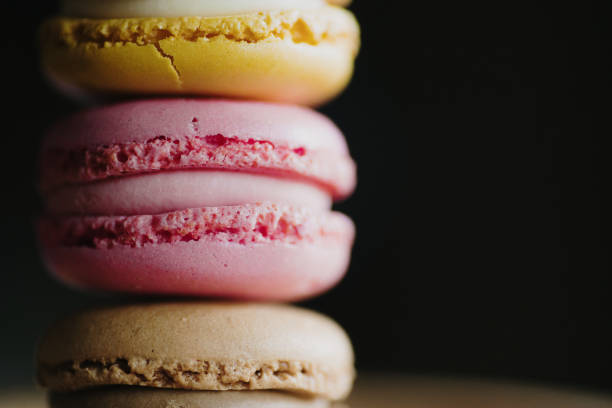 Macarons of different flavors close-up on background