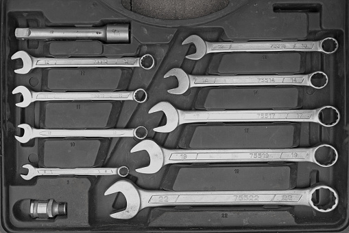 set of wrenches in a large number of close-ups, selective focus. Old, rusty wrenches close-up view from above. Tools for repairing cars and equipment. Set of spanners.