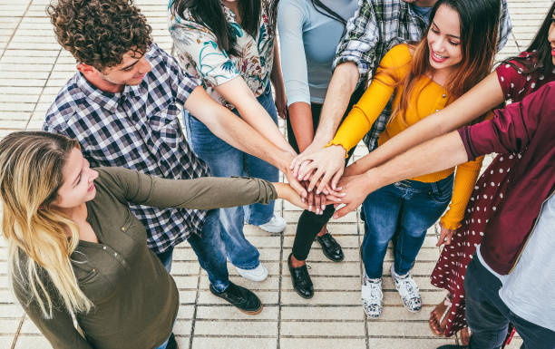 istock Young happy people stacking hands outdoor - Focus on hands 1444430989