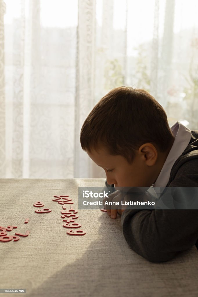 Man Learning Numbers A Boy Learns To Count At His Desk Using Plastic Numbers Stock Photo ...