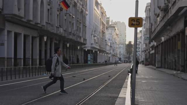 Asian Chinese man tourist exploring crossing tramway Casablanca, Morocco in the morning