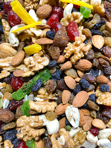 Stock photo showing a healthy snack of mixed nuts and dried fruits. This snack is high in vitamins, minerals, fibre, Omega-3 fatty acids, antioxidants and protein which health benefits include an energy boost and stress reduction.