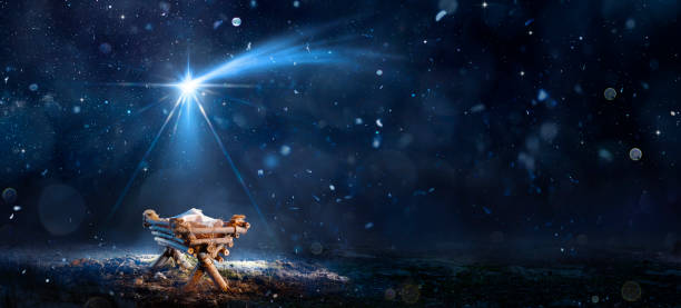 nativity scene - birth of jesus christ with manger in snowy night and starry sky - abstract defocused background - kerststal stockfoto's en -beelden