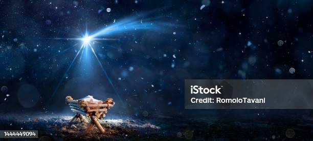 Nativity Scene Birth Of Jesus Christ With Manger In Snowy Night And Starry Sky Abstract Defocused Background Stock Photo - Download Image Now