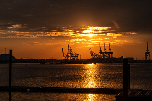 8/16/2022:  Port of Southampton, Hampshire, England, United Kingdom - Sunset falls behind Ship to Shore - STS - Panamax and Megamax cranes in the British Port of Southampton