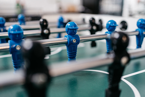Close up soccer table with blue and black figures