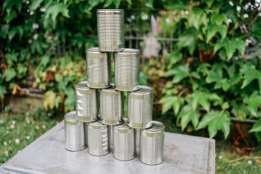 Stack made of silver cans for throwing cans in the garden