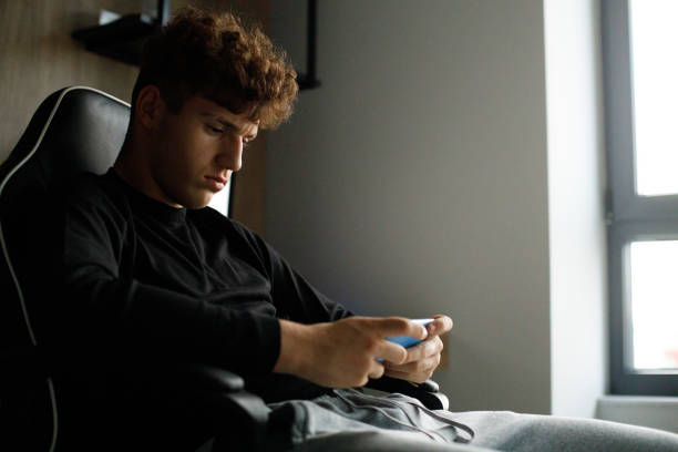istock Teenager boy using the mobile phone 1444453243