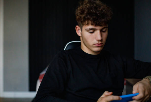 istock Teenager boy using the mobile phone 1444453270