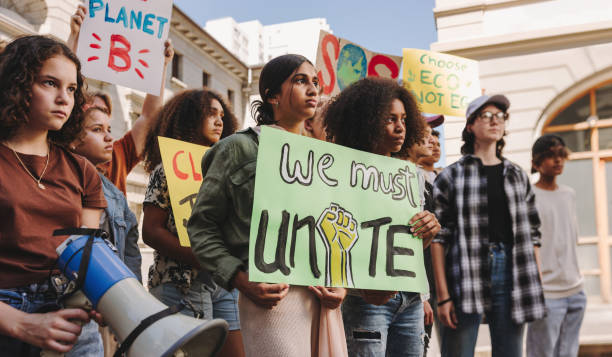 istock Group of diverse young people marching against climate change 1444454534